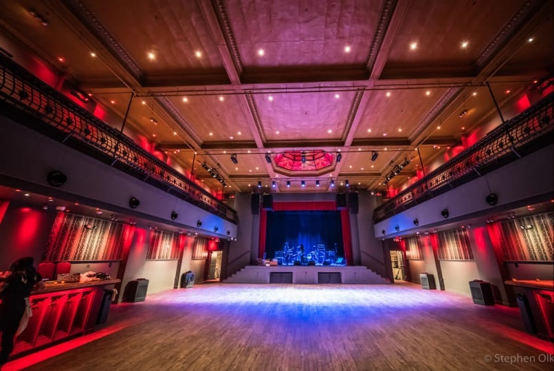 Empty dance floor and stage with band equipment set up for a live concert at White Eagle Hall