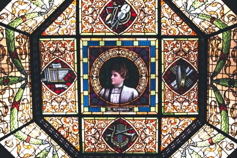 Historic stained-glass skylight ceiling at White Eagle Hall featuring a portrait of opera singer Marcella Sembrich